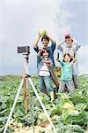 Family taking memorable photograph in field