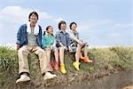 Family sitting on field