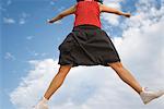 Young woman jumping in midair, cropped