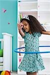 Little girl playing with plastic hoop