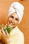 Woman in the bathroom with a bunch of camomile