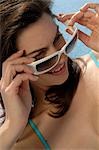 Woman with sunglasses next to the swimming pool