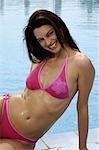 Woman with a pink bikini at the swimming pool