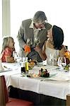 Family at a set table with wine glasses