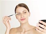 Woman with an eye shadow brush