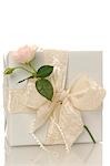 White gift with a pink rose