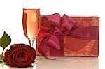 Arrangement of gifts,rose and glass of sparkling wine