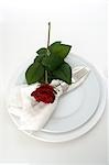 Place setting with a red rose