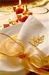 Christmas table place setting,napkin tied with a golden ribbon