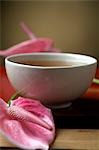 Pink flamingo flower blossoms and a bowl