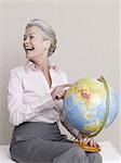 Senior adult with a globe