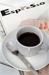 Espresso cup on newspaper