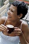 Young woman drinking cappuccino