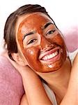 Young woman with chocolate mask