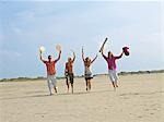 Four young people on the beach