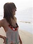 Young woman on the beach in a summer dress