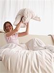 young woman in pillow fight