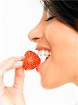 Woman eating a strawberry