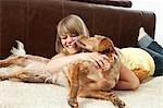 Pet dog licking a young woman's face