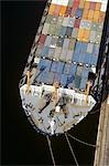 AERIAL OVER BOW OF DOCKED CONTAINER SHIP