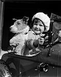 1930s CHILD SITTING IN CAR WITH DOG TOY STEERING