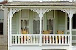 CAPE MAY NEW JERSEY WHITE PAINTED WOOD PORCH WITH WICKER ROCKING CHAIRS SUMMER NOSTALGIA SEASHORE VICTORIAN VACATION