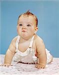 1960s BABY MAKING FUNNY FACE PUSHED UP ON ARMS CRAWLING FORWARD