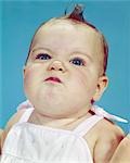 1960s BABY PORTRAIT MAKING FUNNY FACE FROWN SMUG SMELL FACIAL EXPRESSION