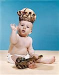 1960s BABY WEARING CLOTH DIAPER AND CROWN OF KING HOLDING A ROYAL MONARCH SCEPTER WAVING WITH ONE ARM RAISED