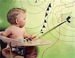 1960s BABY IN HIGH CHAIR USING WOODEN POINTER TO INDICATE LOW PRESSURE AREA ON WEATHER MAP
