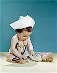 1960s BABY WEARING NURSE NURSE'S CAP STETHOSCOPE LISTENING TO DOLL HEARTBEAT CHEST