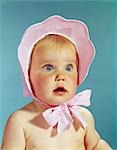 1960s VERY CUTE BLOND BLUE EYED BABY WEARING RED WHITE CHECKED BONNET HAT TIED IN BOW AT CHIN