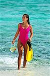 1990s WOMAN IN PINK BATHING SUIT HOLDING SNORKELING GEAR TOBAGO CAYS, WEST INDIES