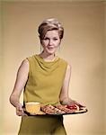 1960s WOMAN SERVING SNACKS HORS D'OEUVRES TRAY