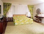 1970s BEDROOM WITH GREEN AND YELLOW FLOWERED BEDSPREAD AND DRAPES