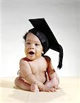 1960s AFRICAN-AMERICAN BABY WEARING GRADUATION CAP