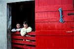 LOCAL BOY GIRL RED BARN DOOR KILLYBEGS COUNTY DONEGAL IRELAND