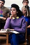 1980s ATTENTIVE FEMALE COLLEGE STUDENT PURPLE SWEATER IN CLASSROOM