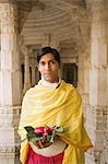 Teenage boy holding religious offering in a temple, Adinath Temple, Jain Temple, Ranakpur, Pali District, Udaipur, Rajasthan, India