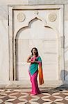 Woman greeting in front of a mausoleum, Taj Mahal, Agra, Uttar Pradesh, India