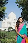 Woman with her eyes closed in front of a mausoleum, Taj Mahal, Agra, Uttar Pradesh, India