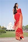 Woman standing in front of a mausoleum, Taj Mahal, Agra, Uttar Pradesh, India