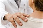 Doctor's hand on patient's shoulder