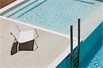 Chair at edge of pool near ladder