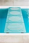 Stepping stones leading across swimming pool