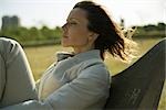 Woman relaxing outdoors, eyes closed