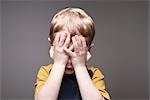Boy Covering Face