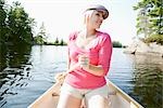 Woman Canoeing on Kahshe Lake, Muskoka, Ontario, Canada