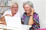 Happy senior couple using laptop