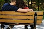 Teenage couple sitting on a bench